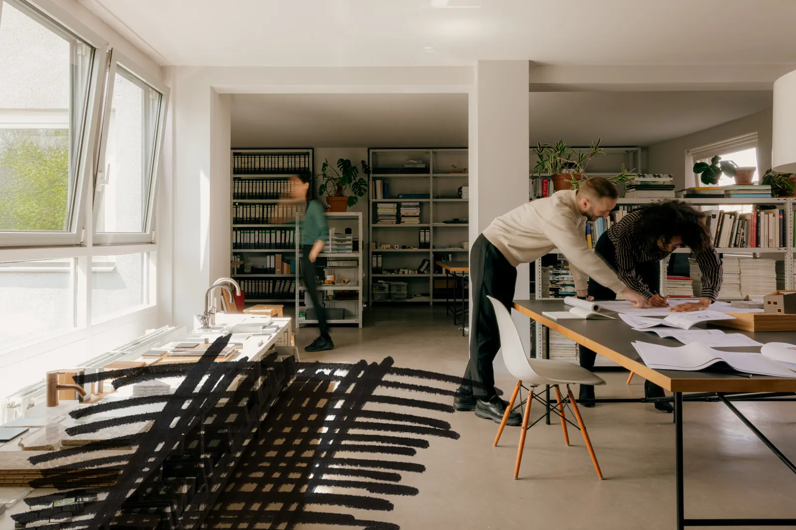 A small studio team working across a shared table